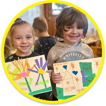 Children showing their artwork